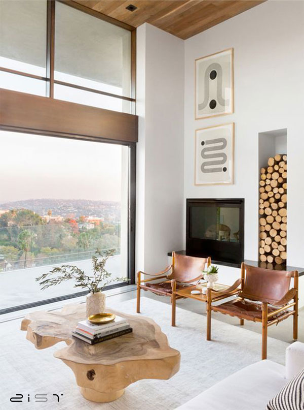 دکور پذیرایی مدرن این منزل تشکیل شده از یک میز جلو مبلی چوبی بسیار زیبا، مبلمان با متریال ساده و یک تابلوی مینیمال.