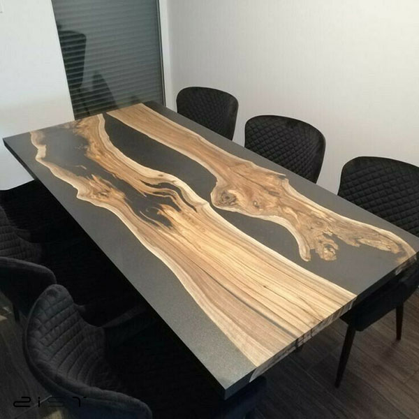 در این تصویر یک نمونه میز چوب و رزین با پایه های مشکی را مشاهده میکنید